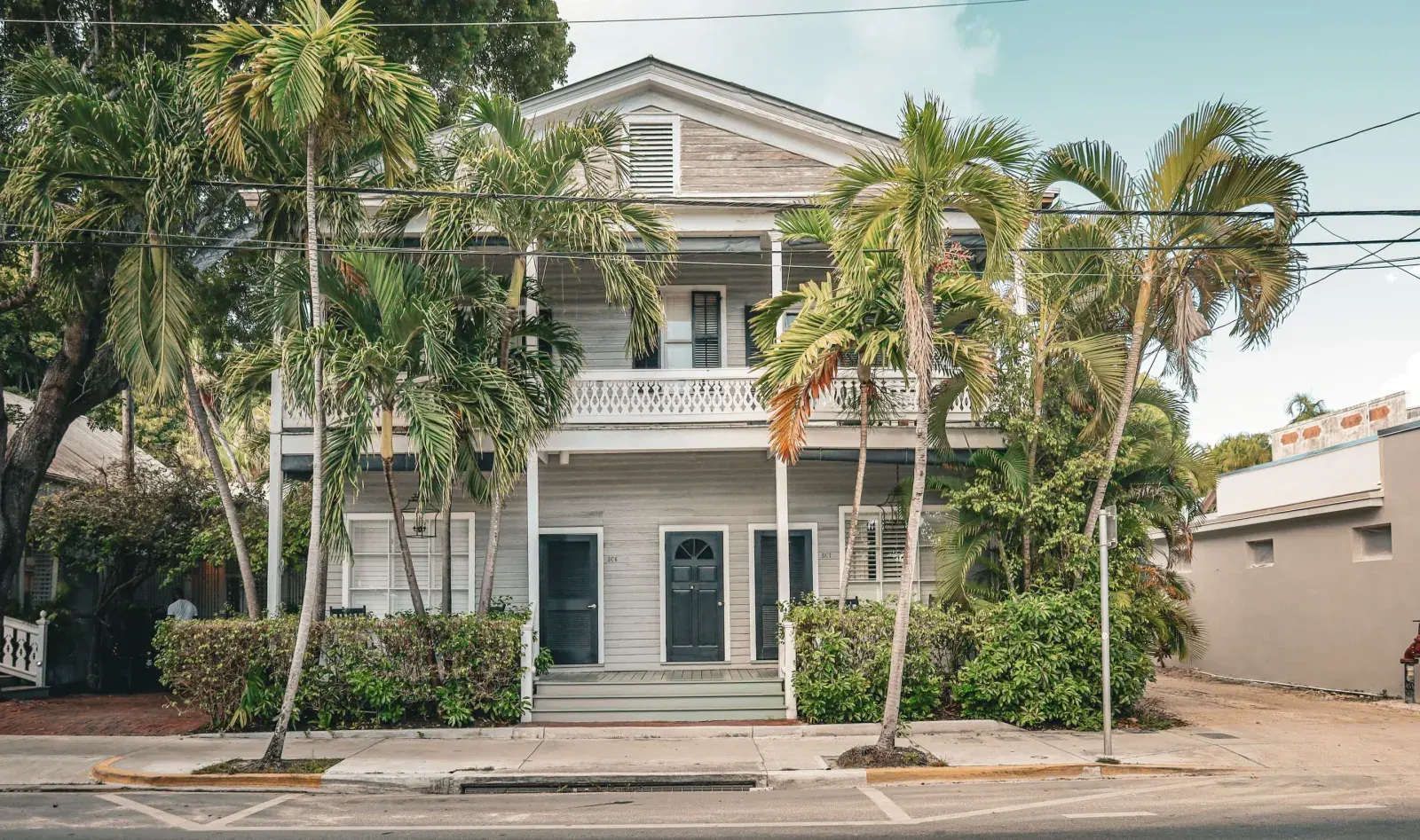 Traditional Florida coastal home with palm trees, representative of Indialantic, FL's older oceanfront homes